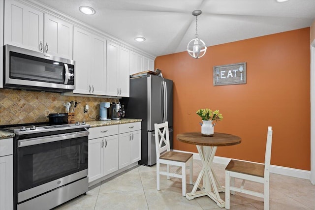 kitchen with decorative light fixtures, white cabinets, and stainless steel appliances