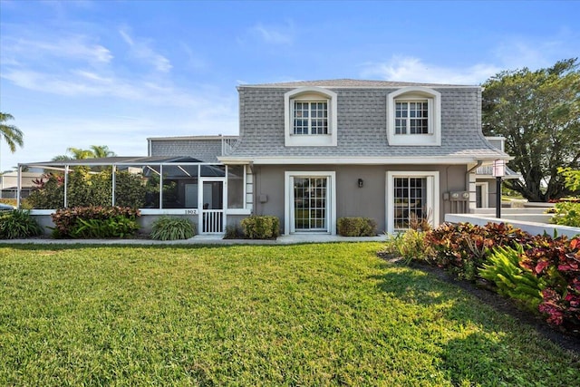 back of property with a lanai and a yard