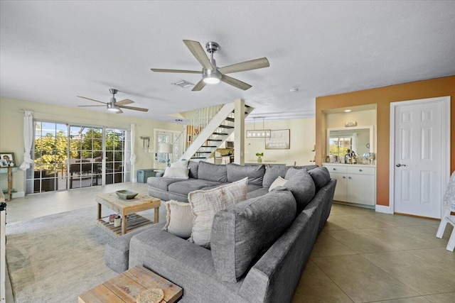 living room with ceiling fan and light tile patterned floors