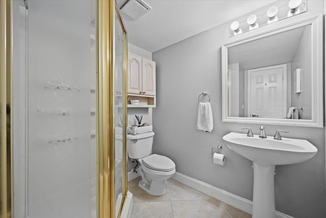 bathroom featuring toilet, tile patterned flooring, sink, and walk in shower