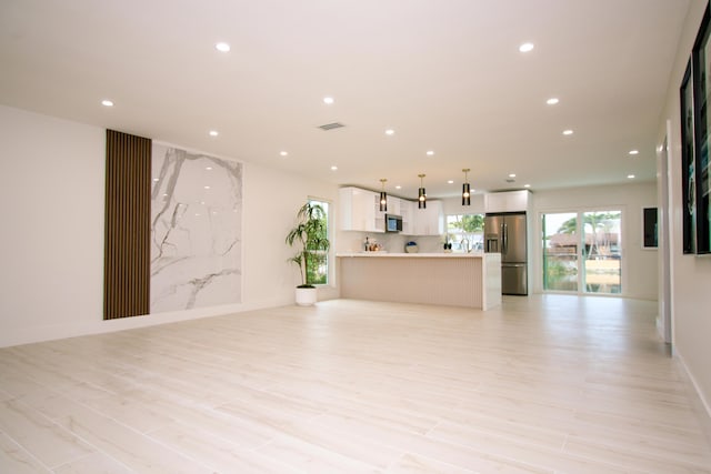 unfurnished living room with light hardwood / wood-style floors