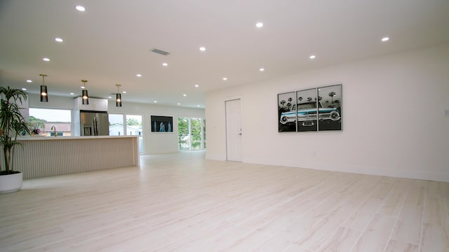 unfurnished living room featuring light hardwood / wood-style floors