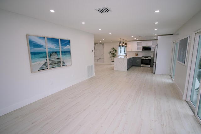 unfurnished living room featuring light wood-type flooring