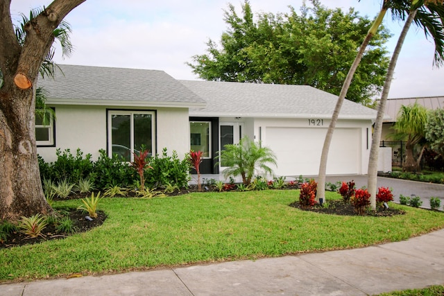 single story home with a garage and a front yard