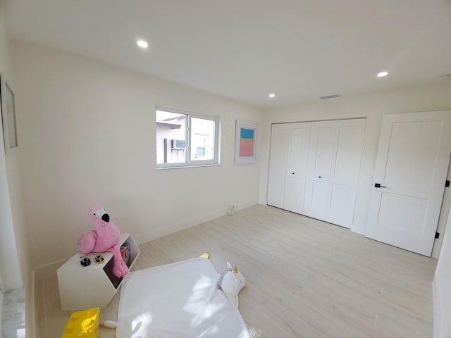 bedroom with a closet and light hardwood / wood-style floors