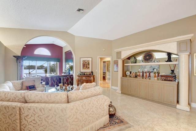 living room with a textured ceiling and vaulted ceiling