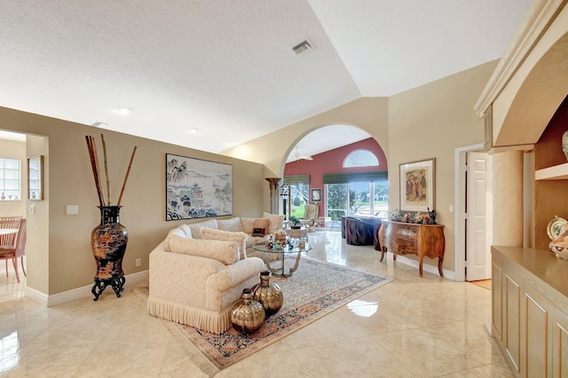 living room with vaulted ceiling and a textured ceiling