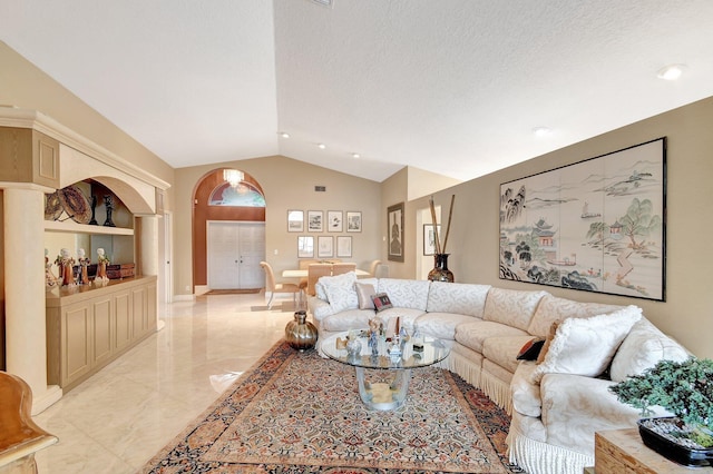 living room featuring a textured ceiling and lofted ceiling