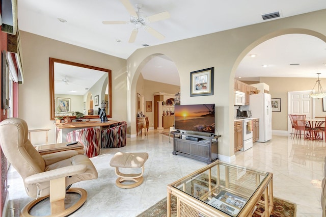 living room with lofted ceiling and ceiling fan