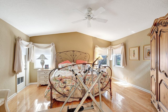 bedroom featuring light hardwood / wood-style flooring, vaulted ceiling, and ceiling fan