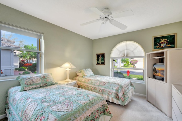 bedroom featuring ceiling fan and light carpet