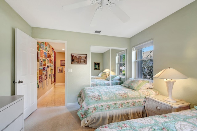 bedroom with light carpet and ceiling fan