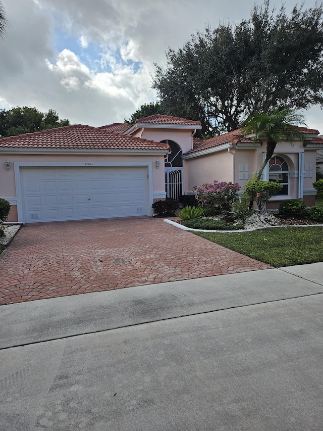 mediterranean / spanish-style house with a garage