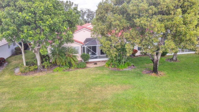 view of yard with glass enclosure