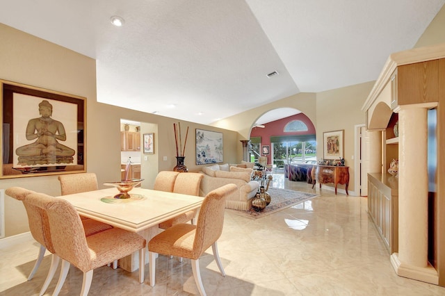 dining space featuring vaulted ceiling