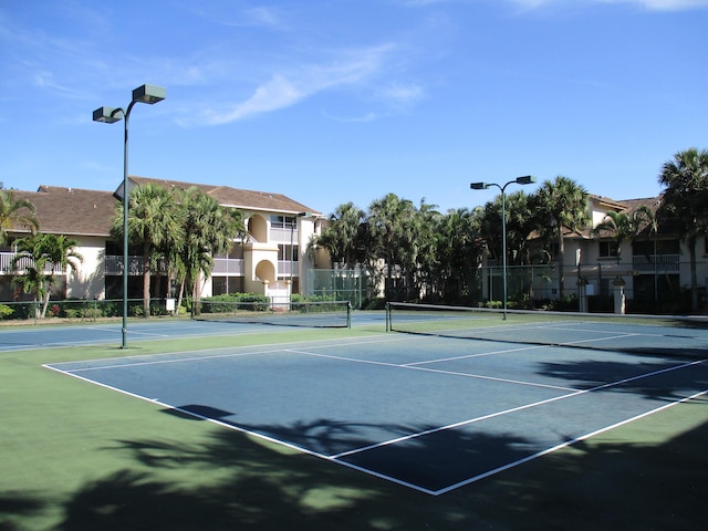 view of sport court featuring fence