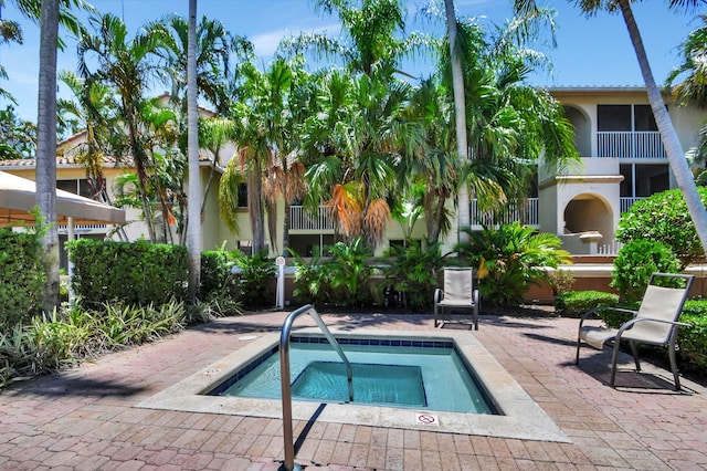 view of swimming pool featuring a patio area and a hot tub