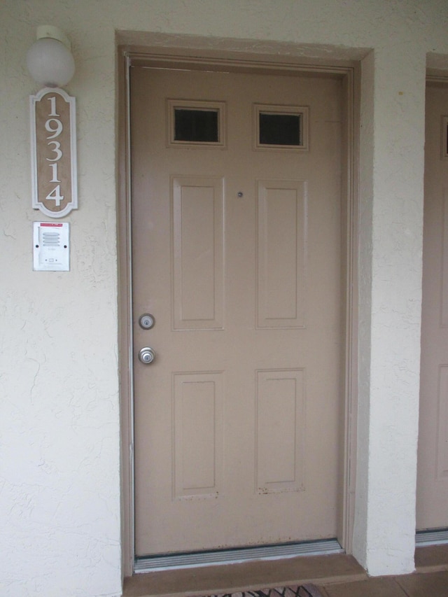 entrance to property with stucco siding