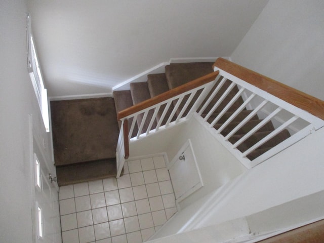 staircase featuring tile patterned floors