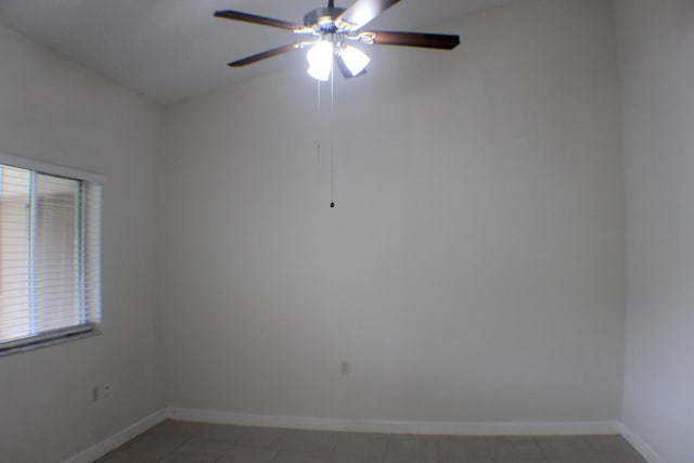 empty room with ceiling fan and baseboards