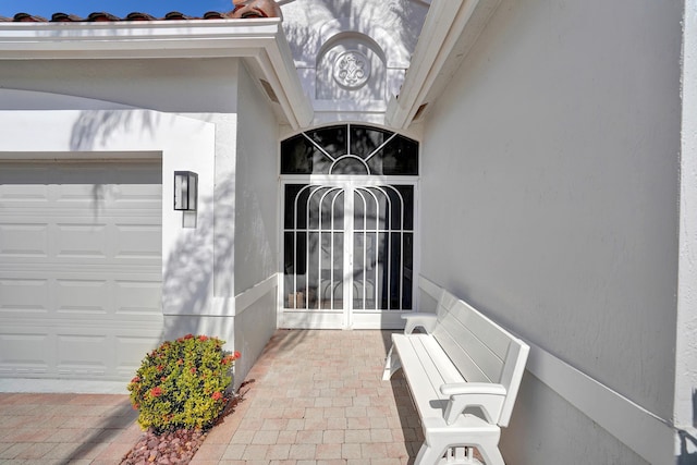 view of exterior entry featuring a garage