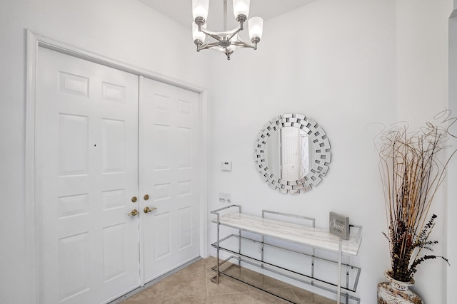 foyer featuring light tile patterned flooring and an inviting chandelier