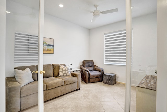 living room featuring ceiling fan and tile patterned floors