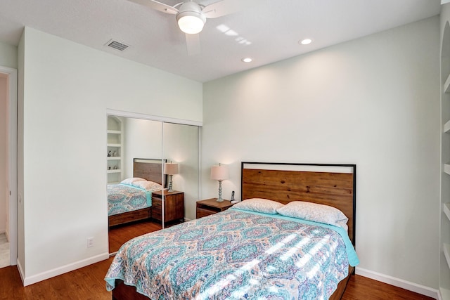 bedroom featuring ceiling fan, dark wood-type flooring, and a closet