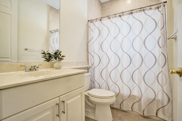 bathroom with tile patterned floors, vanity, and toilet