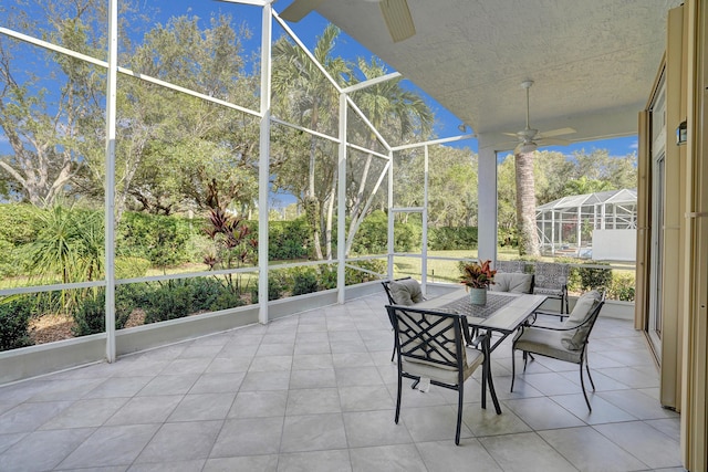 unfurnished sunroom with ceiling fan