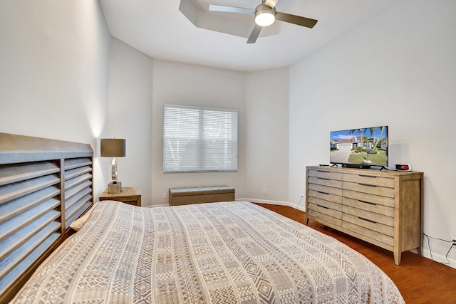 bedroom with ceiling fan and dark hardwood / wood-style floors