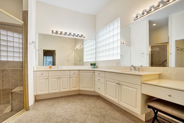 bathroom featuring vanity, tile patterned flooring, and a shower with door