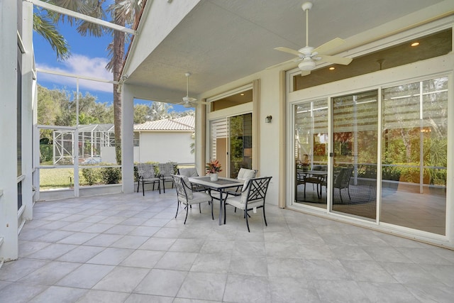 sunroom / solarium featuring ceiling fan