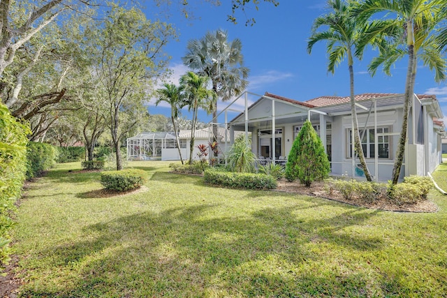 view of yard featuring glass enclosure