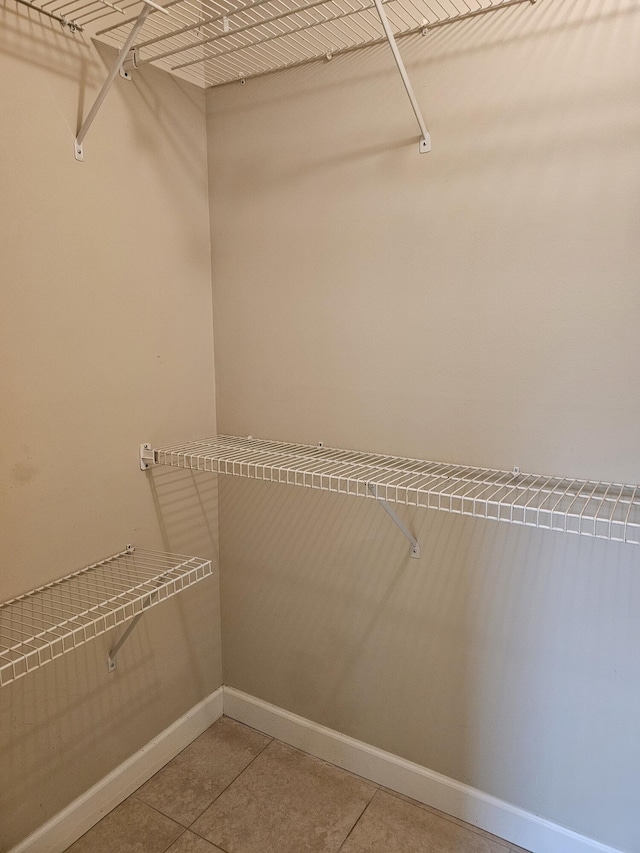 walk in closet with tile patterned floors