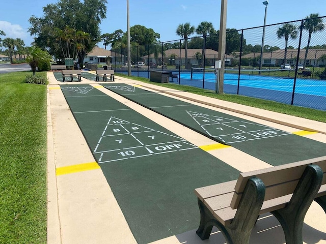 1235 S Lakes End Dr Unit 0, Fort Pierce, FL 34982 - surrounding community featuring a tennis court, shuffleboard, and uncovered parking