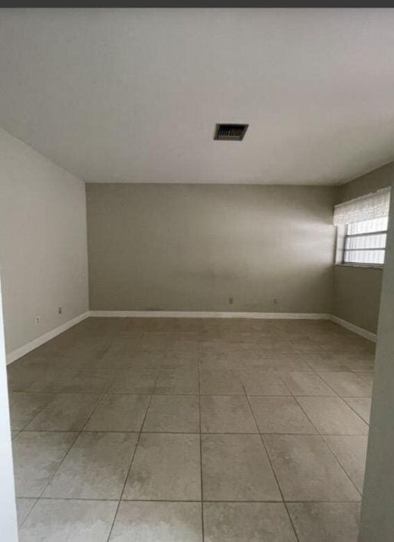 1235 S Lakes End Dr Unit 0, Fort Pierce, FL 34982 - empty room with light tile patterned flooring and baseboards