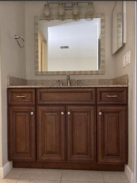 1235 S Lakes End Dr Unit 0, Fort Pierce, FL 34982 - bathroom featuring baseboards, vanity, and tile patterned flooring
