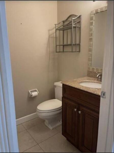 1235 S Lakes End Dr Unit 0, Fort Pierce, FL 34982 - bathroom featuring tile patterned flooring, toilet, vanity, and baseboards