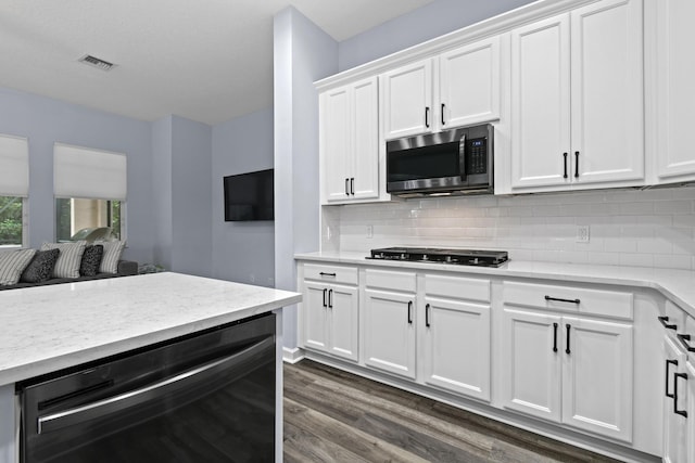 kitchen featuring tasteful backsplash, white cabinets, and black appliances