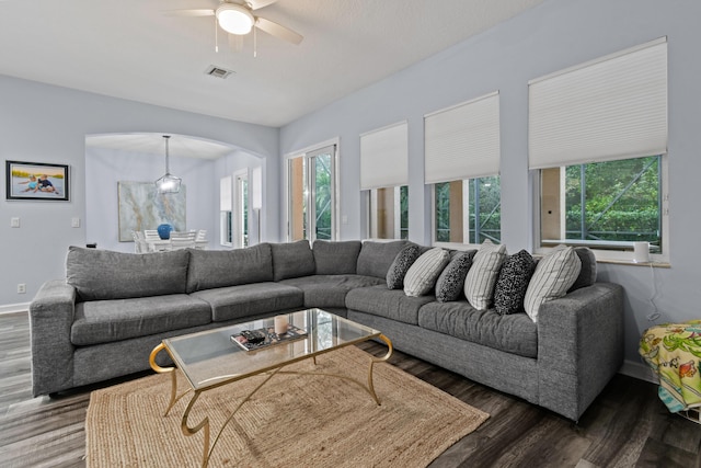 living room featuring hardwood / wood-style floors and ceiling fan