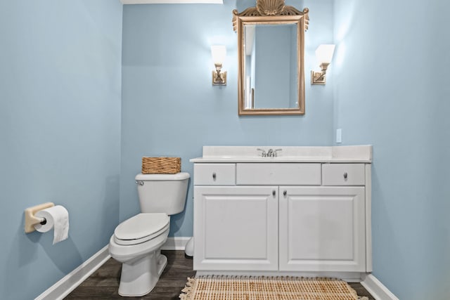 bathroom featuring hardwood / wood-style flooring, vanity, and toilet