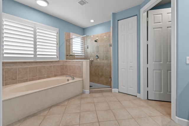 bathroom with tile patterned floors and plus walk in shower