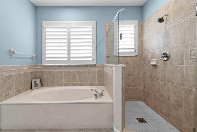 bathroom with independent shower and bath and tile patterned flooring