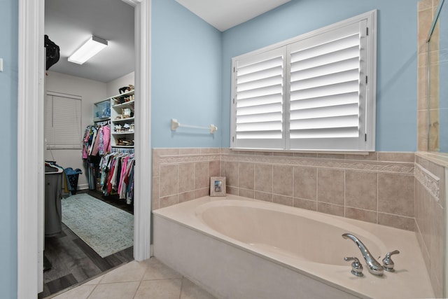 bathroom featuring tile patterned flooring and a washtub