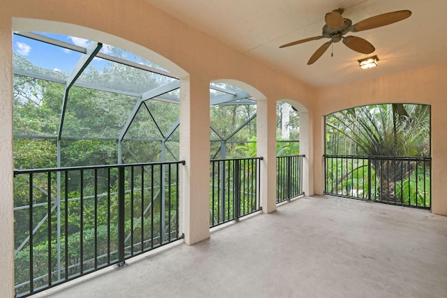 unfurnished sunroom featuring ceiling fan