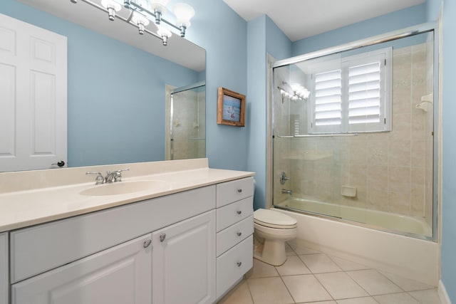 full bathroom featuring tile patterned flooring, vanity, shower / bath combination with glass door, and toilet