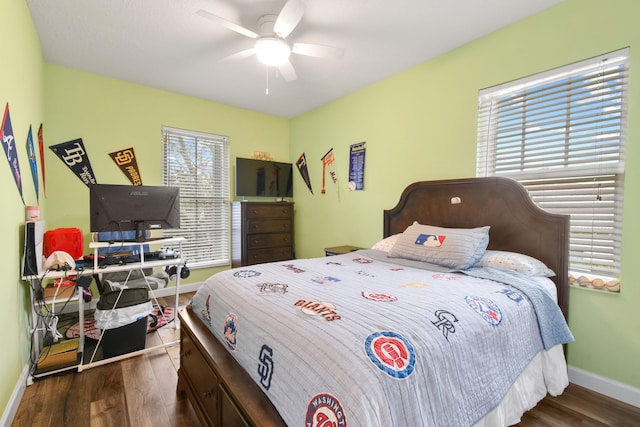 bedroom with dark hardwood / wood-style flooring and ceiling fan