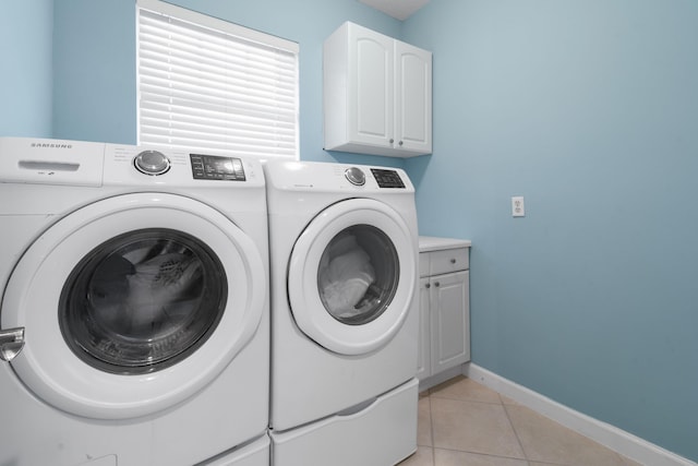 washroom with cabinets, light tile patterned floors, and independent washer and dryer