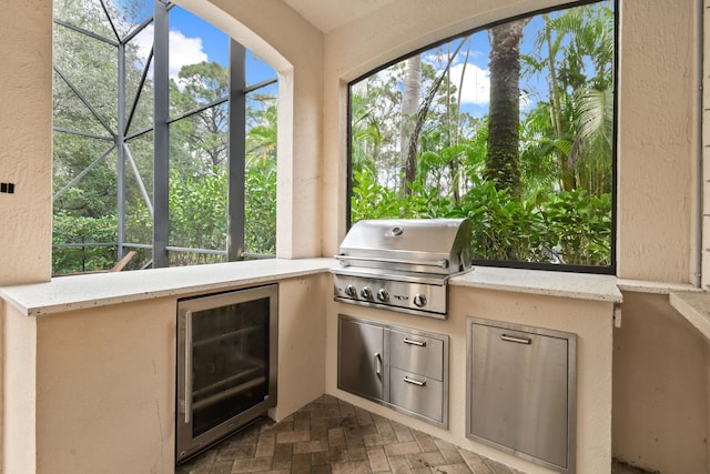 view of patio / terrace with exterior kitchen, area for grilling, and beverage cooler